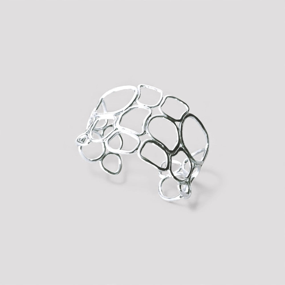 Pulsera en plata BC2S de la colección Candela sobre fondo de color